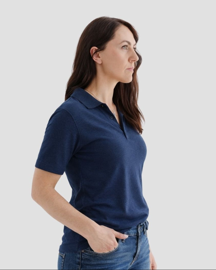 Woman wearing a navy blue polo shirt against a white background