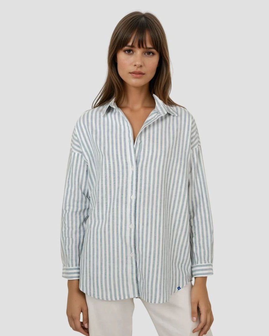 Woman wearing a striped shirt on a plain background