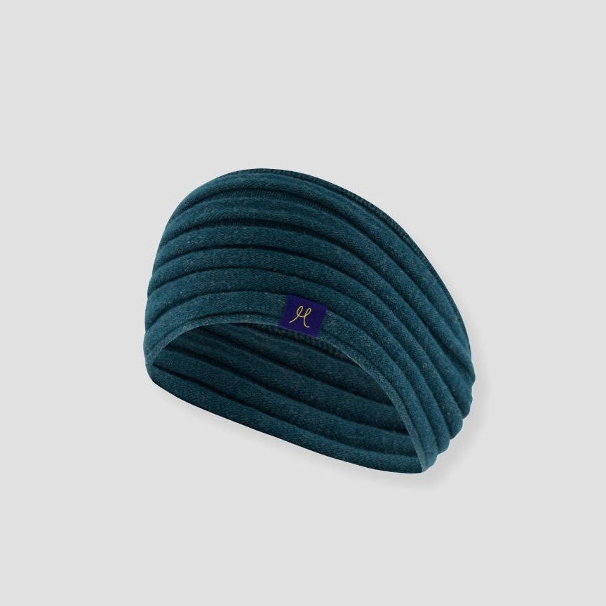 Teal headband with a logo on a light gray background