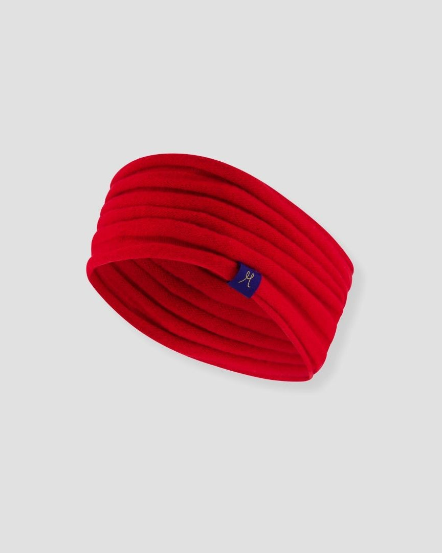 Red headband with a small logo on a light gray background