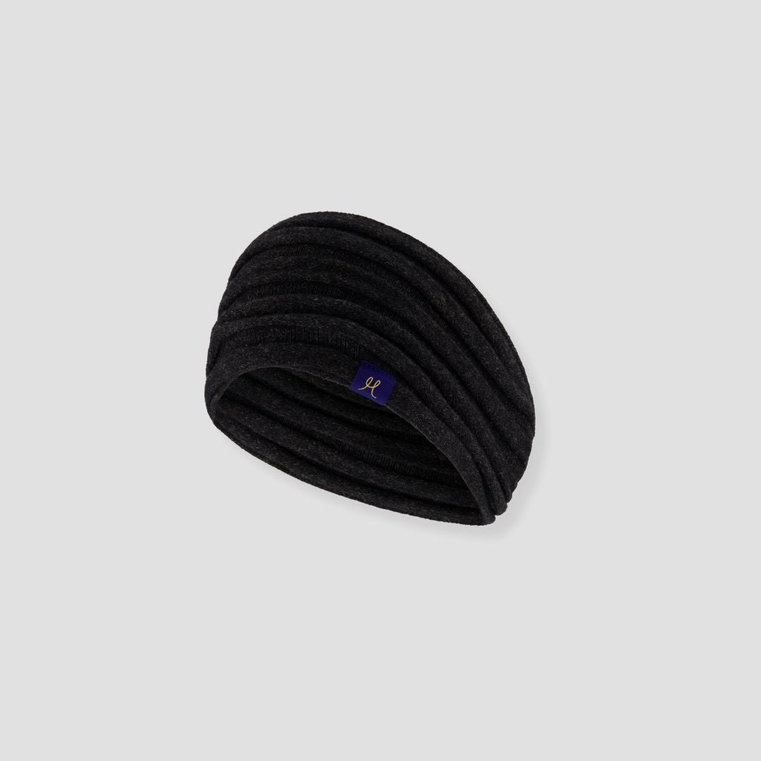 Black headband with a small logo on a light gray background