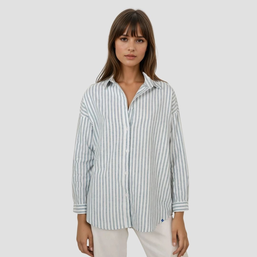 Woman wearing a striped shirt on a plain background