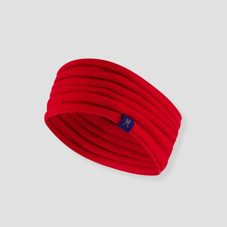 Red headband with a small logo on a light gray background