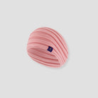 Pink knitted headband with a small logo on a light gray background